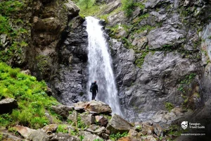 Gveleti Waterfalls near Kazbegi Georgia surrounded by mountains and rocky cliffs on the Georgian Military Highway
