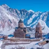 Gergeti Trinity Church in Kazbegi with Mount Kazbek view, best destination to visit by rental car from Tbilisi